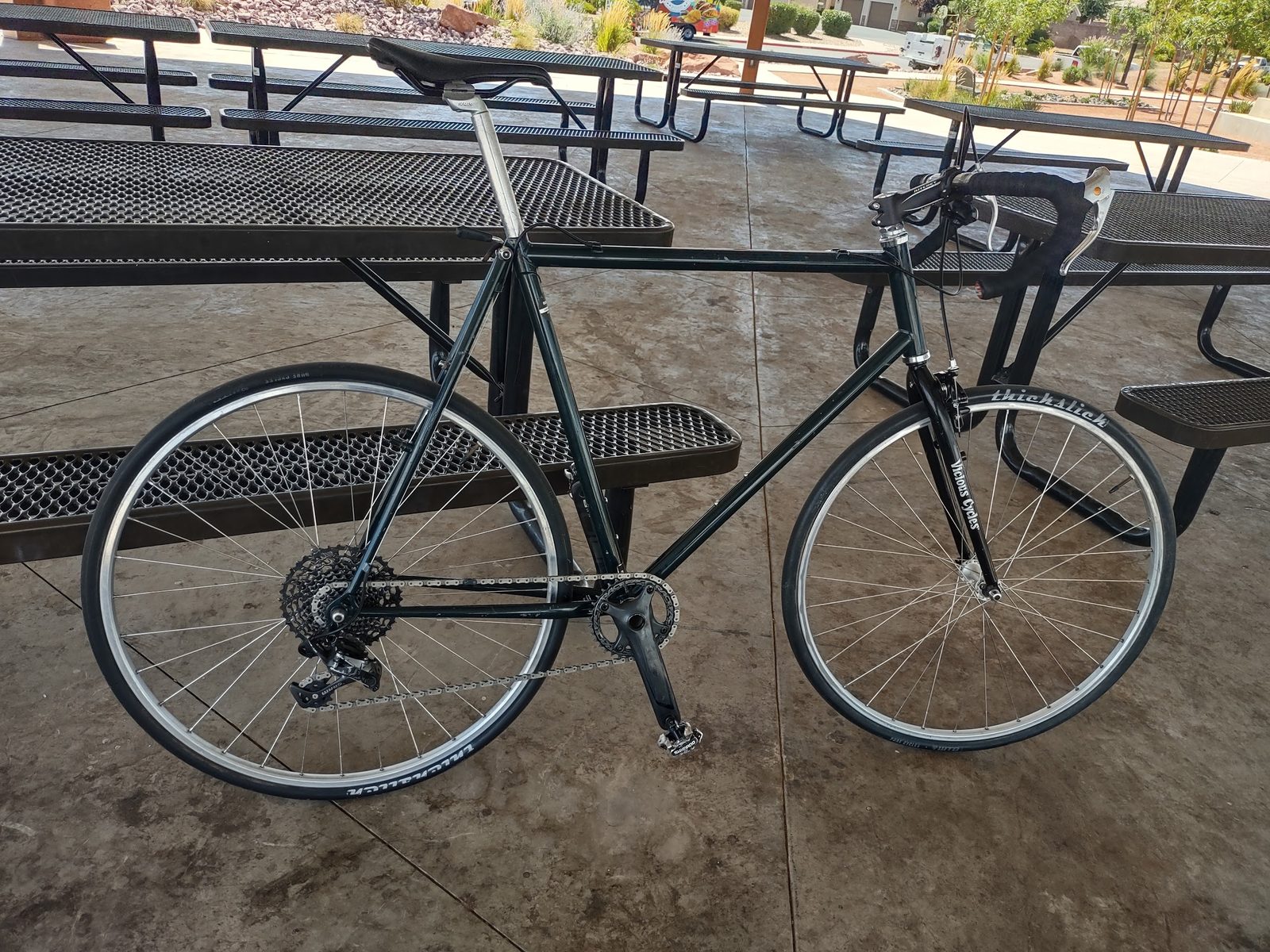 The first build: the frame with spare parts and drop bars, parked by a picnic table